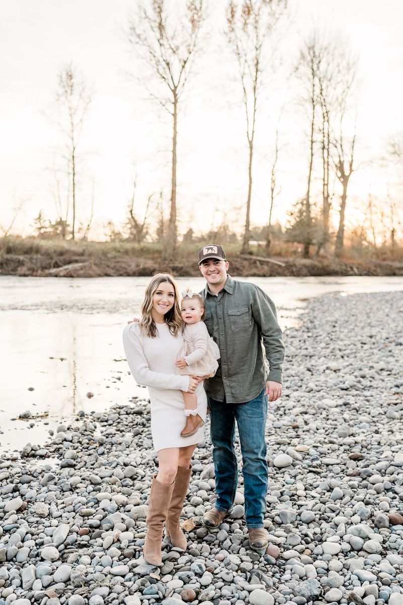 Jake and Lauren Collier with their daughter by the river